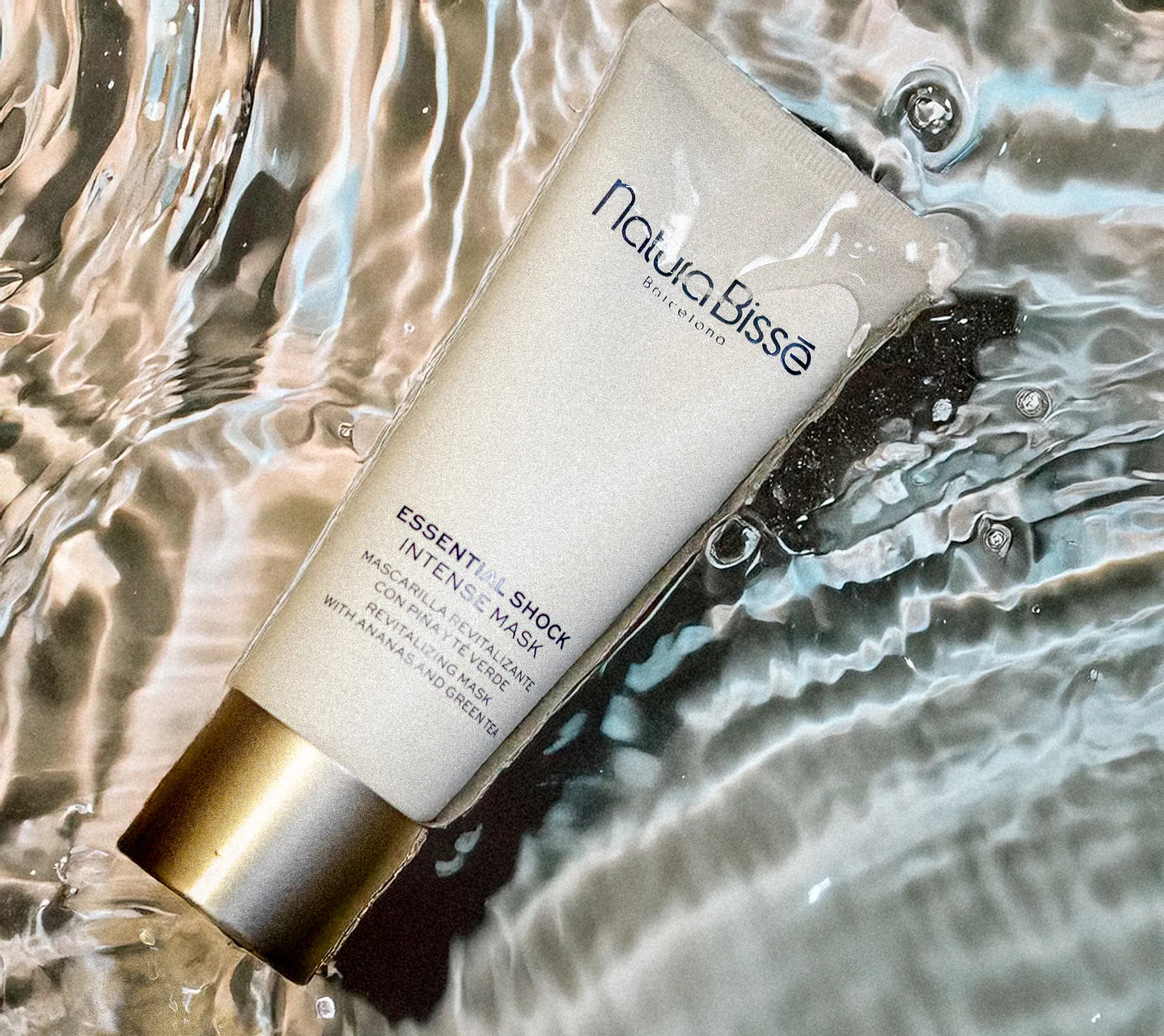 Natura skincare tube photographed in rippling water